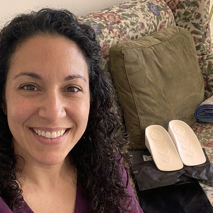 Woman at home beside a pair of white HighPads inserts