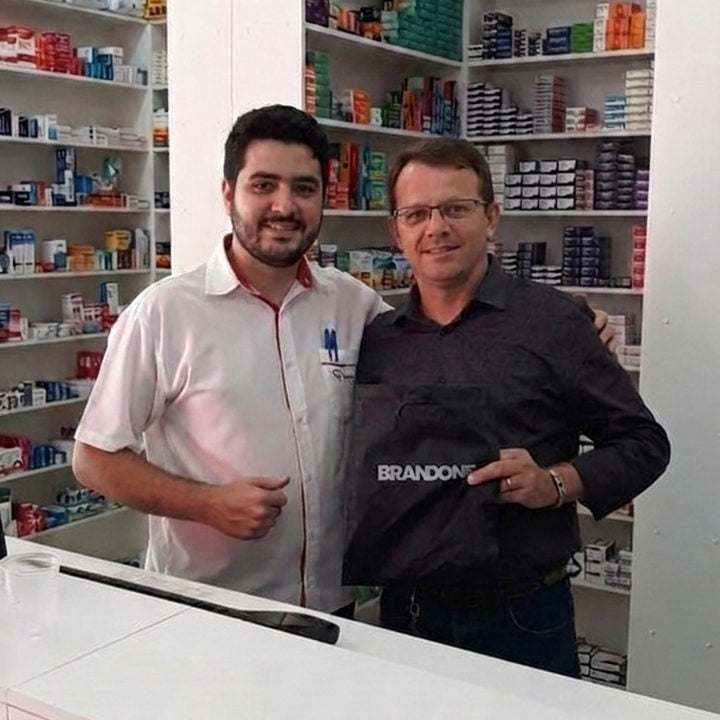 Two men in a shop holding a black BRANDONE bag